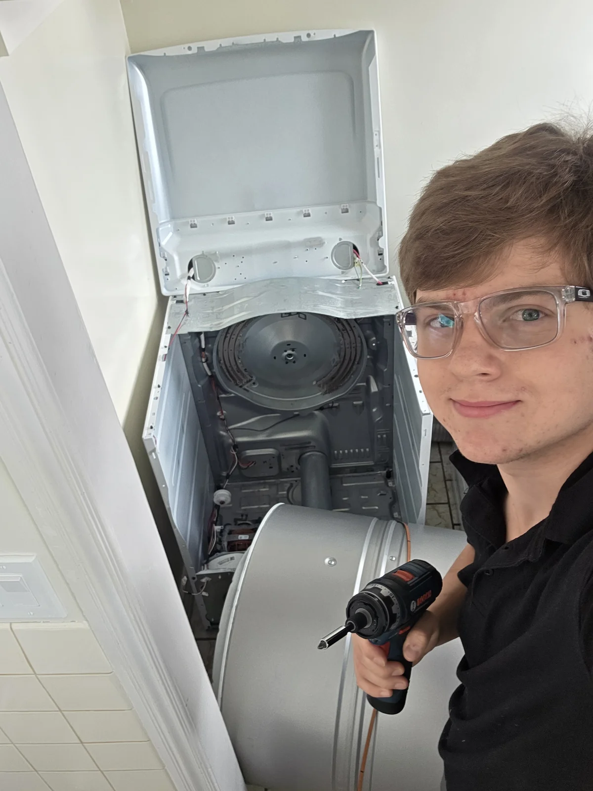 Daniil, UniFix owner-technician, repairing a dryer in San Rafael