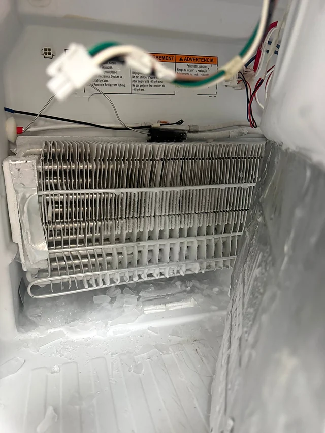 Evaporator coil covered in heavy frost on a refrigerator service call